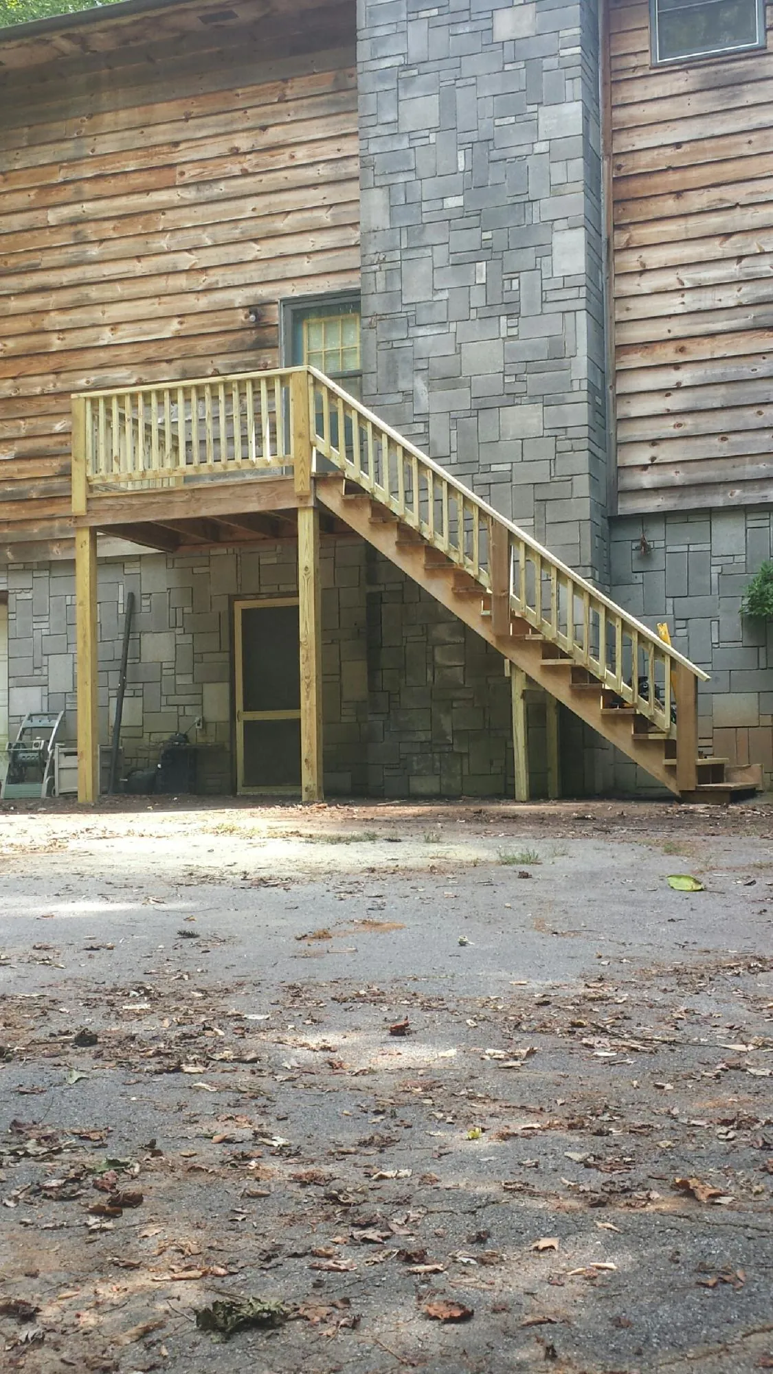 New pressure treated deck and stair landing on a log home in Knights Landing